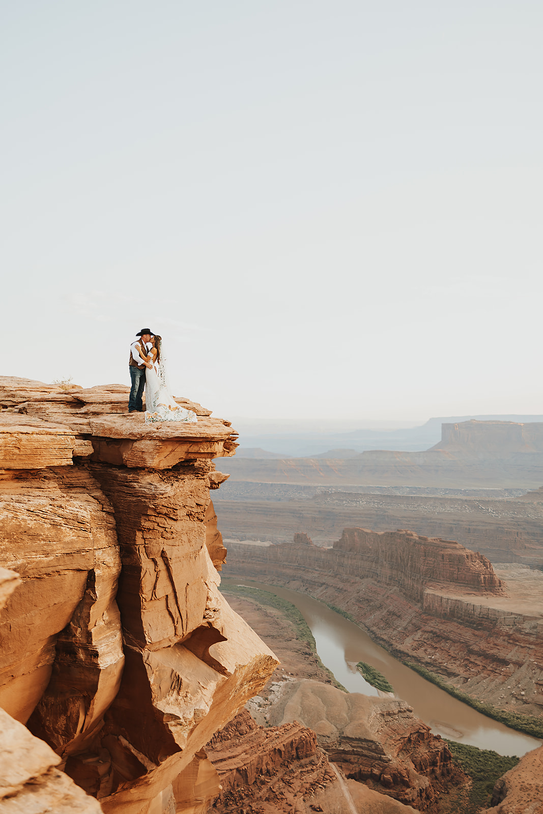 Adventure elopement in Moab, Utah, with a couple on a red rock cliff